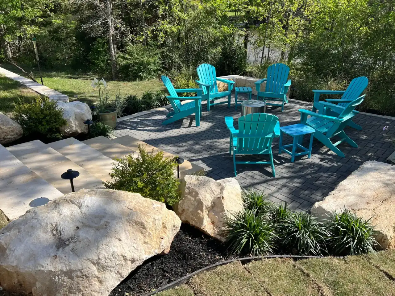 Bryan TX outdoor living space with black paver patio showing the kind of installation Greener Lawnscapes delivers for Brazos Valley homeowners across College Station properties