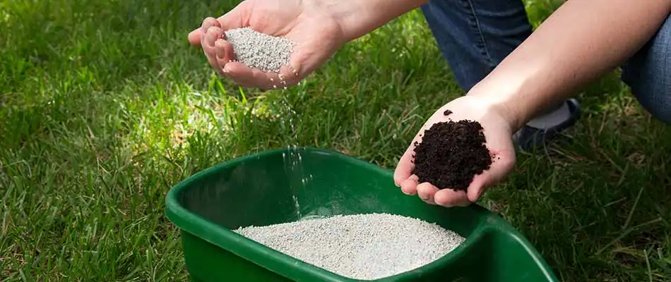 Lawn care worker mixing fertilizer in Bryan, TX.