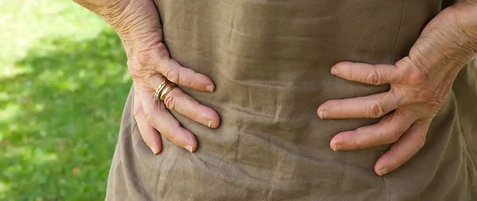 Back pain experienced from pulling weeds in College Station, TX.